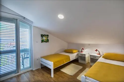 Twin bedroom with balcony access